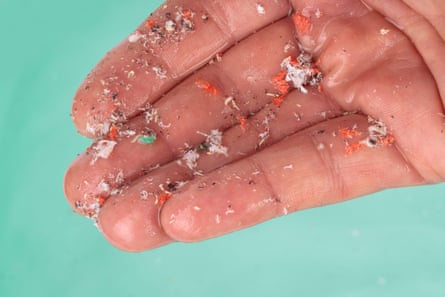 Hand detail showing microplastics.