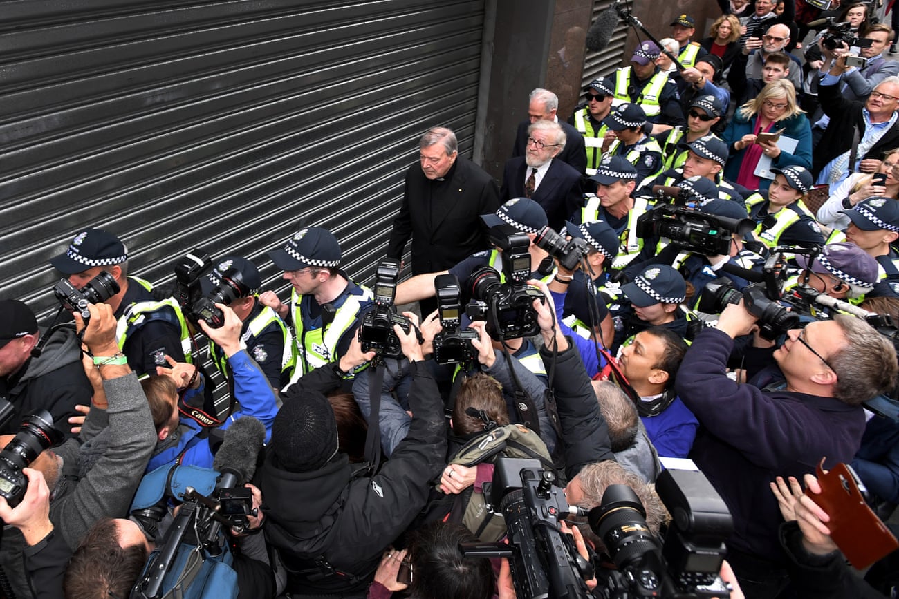 Members of the media surround Pell