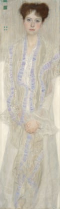 Gustav Klimt’s portrait shows a young woman seated with hands clasped, wearing a flowing white dress