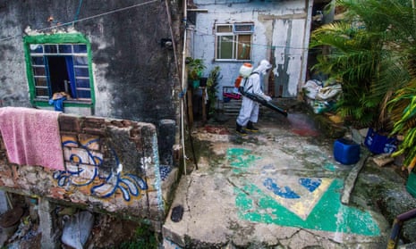 Man in protective gear sprays houses