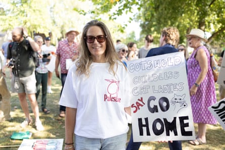 Sue Moon with her placard, which reads ‘We don’t want him. Cotswold childless cat ladies say go home’