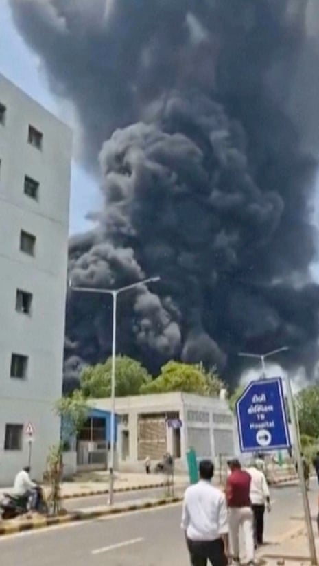 Smoke rises after an aircraft crashed in Ahmedabad, Gujarat state, India, on Thursday.