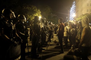 A protester speaks with a Park Police officer standing guard with a line of police closing off off the area around Lafayette Park near the White House after protesters tried to topple a statue of Andrew Jackson