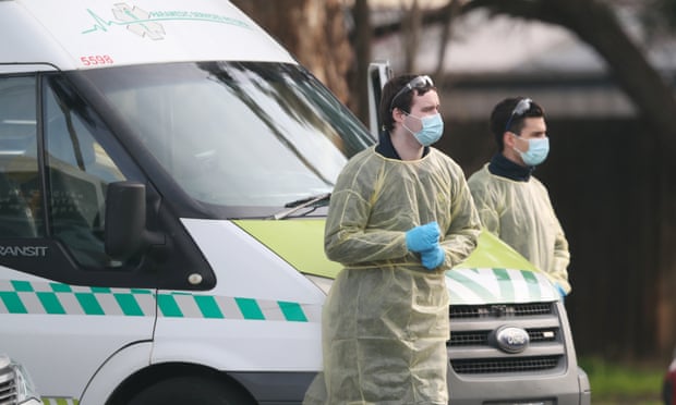Medical staff prepare to transport people from the St Basil’s aged care home in Fawkner, Melbourne, which has had an outbreak of coronavirus. On Sunday Victoria reported 10 Covid-19 deaths and 459 new cases. 