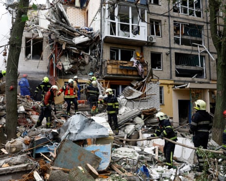 Rescuers work at the site of an apartment building hit during Russian missile and drone strikes, amid Russia’s attack on Ukraine, in Kyiv, Ukraine.