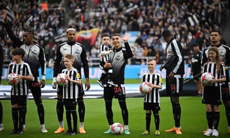 Newcastle United's Miguel Almiron and his teammates line up with the mascots ahead of kick-off against Brighton and Hove Albion at St James' Park.