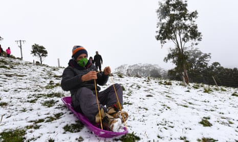 Local residents sled in the snow near Greendale, Victoria, Australia