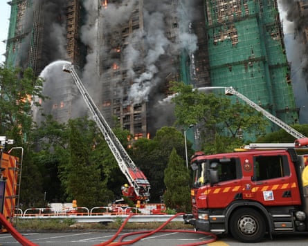 Firefighters tackle a blaze in an apartment block complex