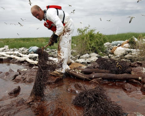 Oil Spill\<br\>FILE- In this June 4, 2010 file photo, a worker picks up blobs of oil with absorbent snare on Queen Bess Island at the mouth of Barataria Bay near the Gulf of Mexico in Plaquemines Parish, La. Nearly \$10 million in 2010 oil spill money is rebuilding the barrier island bird rookery off Louisiana. Work on Queen Bess Island had to wait for this yearâs nesting season to end in August and must finish by late February or early March, before the next nesting season. The island, which was heavily hit by oil from the Deepwater Horizon spill, supports Louisianaâs third-largest brown pelican nesting colony. (AP Photo/Gerald Herbert, File)