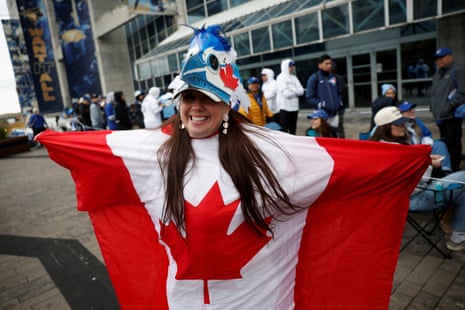 Kelly Wendt wraps herself in Canada's flag before Game 6.