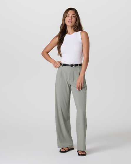model in white top and grey trousers