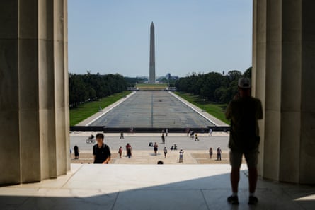 people walk by the drained Lincoln Memorial Reflecting Pool