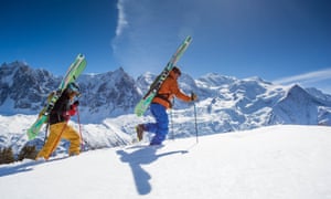 Two skiers walking in the snow in Chamonix, France