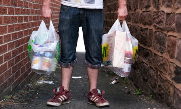 Anonymous user of a Rotherham food bank holds two bags full of items