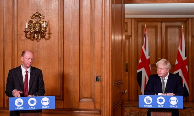 The chief medical officer, Chris Whitty, with Boris Johnson as the PM announces his three-tier plan on Monday.