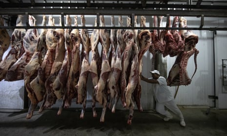 A worker moves cattle carcasses at the municipal slaughterhouse in Sao Felix do Xingu, Brazil