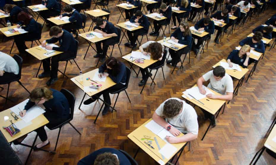 Welsh pupils sitting their GCSEs in an exam hall.a