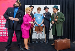 Staff and people in costumes of Tintin characters pose with the new Belgium away kit, inspired by The Adventures of Tintin comic book by Herge