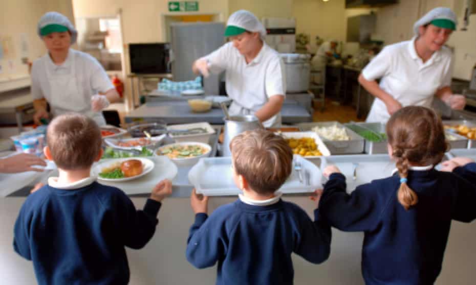 children being served meal at school