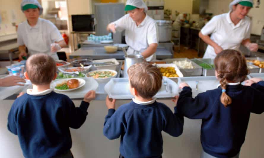 Schoolchildren being served lunch