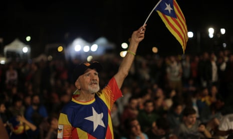 A man waves an estelada, or Catalonia independence flag, during a gathering at Plaza Catalonia in Barcelona on the day of the referendum