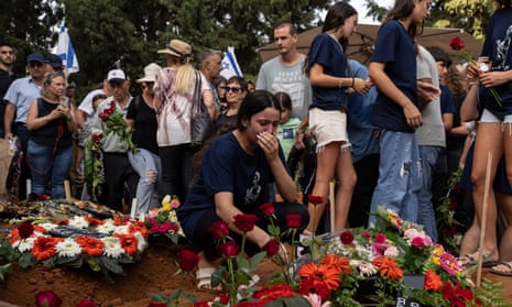 Family and friends weep at the graveside.
