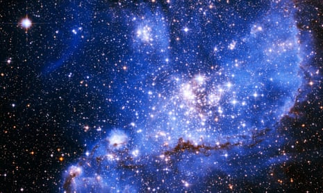 A bight blue cloud of dust and gas in deep space