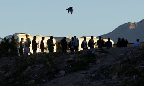 Asylum-seeking migrants cross the Rio Bravo river in Ciudad Juarez in El Paso, Texas, on 23 September.