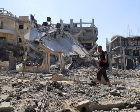 Palestinian man Jehad al-Shagnobi, who was injured in an earlier Israeli strike on his house, walks with an external fixator on his arm to inspect the damage at his home in Sabra neighbourhood, after an Israeli operation, at Sabra neighbourhood in Gaza City, on Wednesday, 8 October 2025.