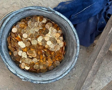 A bucket filled with gold coins