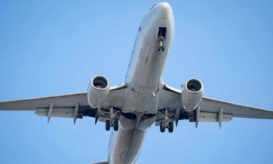An airplane is shown on a background of blue sky.