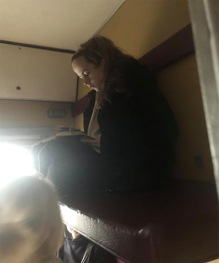 The author writing her diary on the train