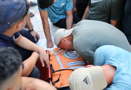 People crying over a shrouded body
