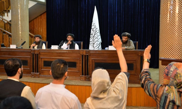 Taliban spokesperson Zabihullah Mujahid gestures towards journalists at a press conference in Kabul on 24 Mujahid