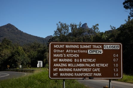 A sign showing the track closure to Mt Warning with Mt Warning in the background.