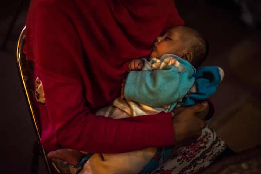 A 17-year-old girl holds her one-month-old son at a women's shelter in Kabul in 2017