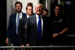 Former president Donald Trump comments to members of the media while returning to the courtroom.