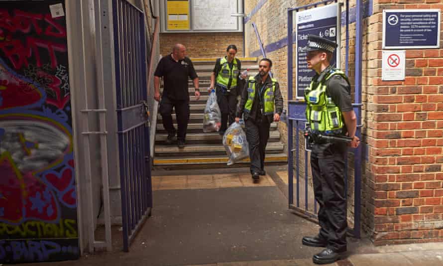 British Transport Police officers carry evidence bags as they leave from Brixton train station after investigating the deaths at Loughborough Junction.