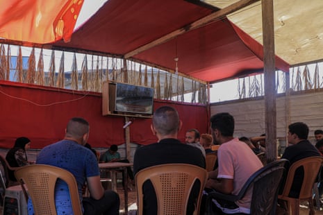 Palestinians watch Friday’s international court of justice ruling at a cafe in Khan Younis.