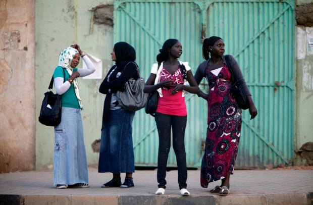 Women wait for public transport in Khartoum in 2012