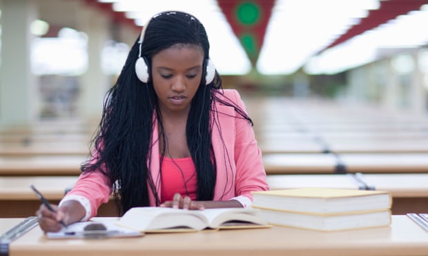 A girl studying while listening to music