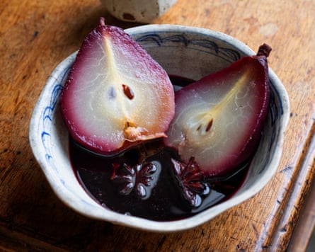 Spiced pears with red wine and dark chocolate in a white pottery bowl