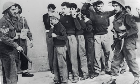 Two British soldiers on left with group of nine young men in civilian clothes