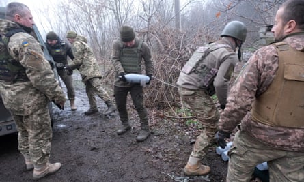 Ukrainian troops from the 24th mechanised brigade take deliveries of shells
