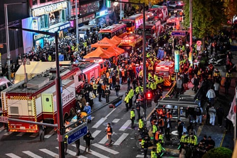 Onlookers, police and paramedics gather where dozens of people suffered cardiac arrest.