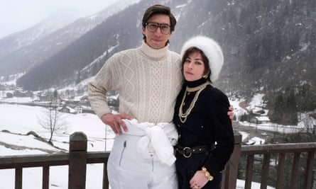 Adam Driver and Lady Gaga in a scene from House of Gucci, with snow-capped mountains behind them