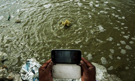 ndians take pictures of contaminated water at the Vijyaipura landfill near Bangalore