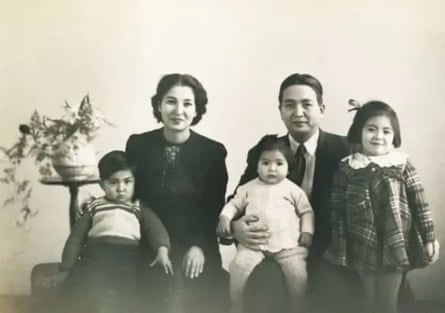 A photograph of a seated family of five