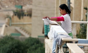 A maid from the Philippines on the balcony of her employer’s house in Amman, Jordan, in 2008.
