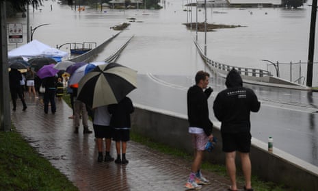 Onlookers watch the submerged New Windsor Bridge at Windsor in the north west of Sydney, Australia, 22 March 2021.